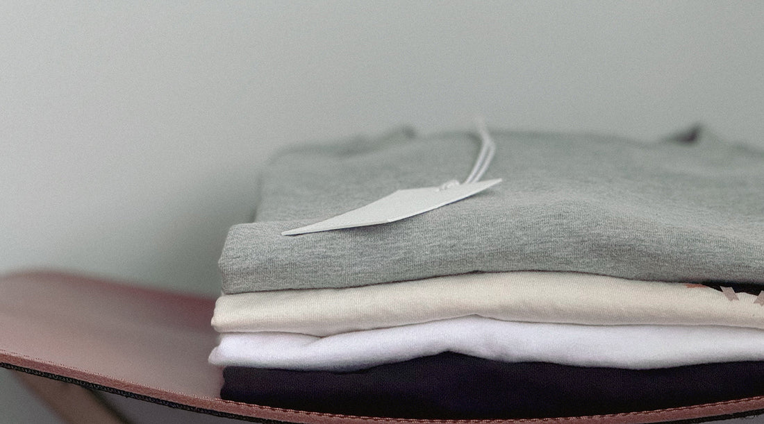 Stack of folded t-shirts in neutral colors